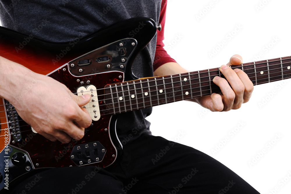 Fototapeta premium Young man playing on electric guitar close up