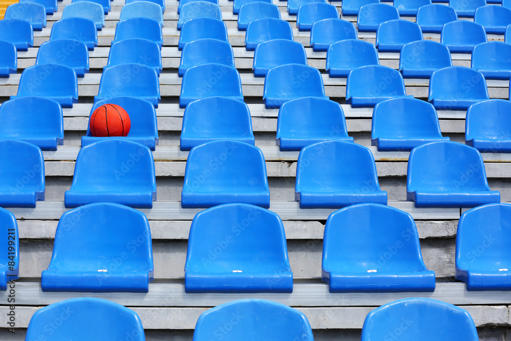 Naklejka premium Basketball ball on stadium seat