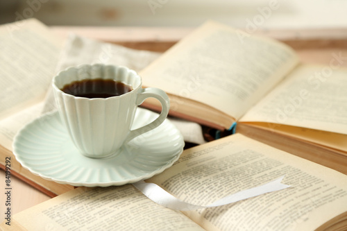 Still life with cup of coffee and books, close up photo