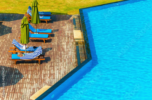  Luxury swimming pool with blue sun loungers 