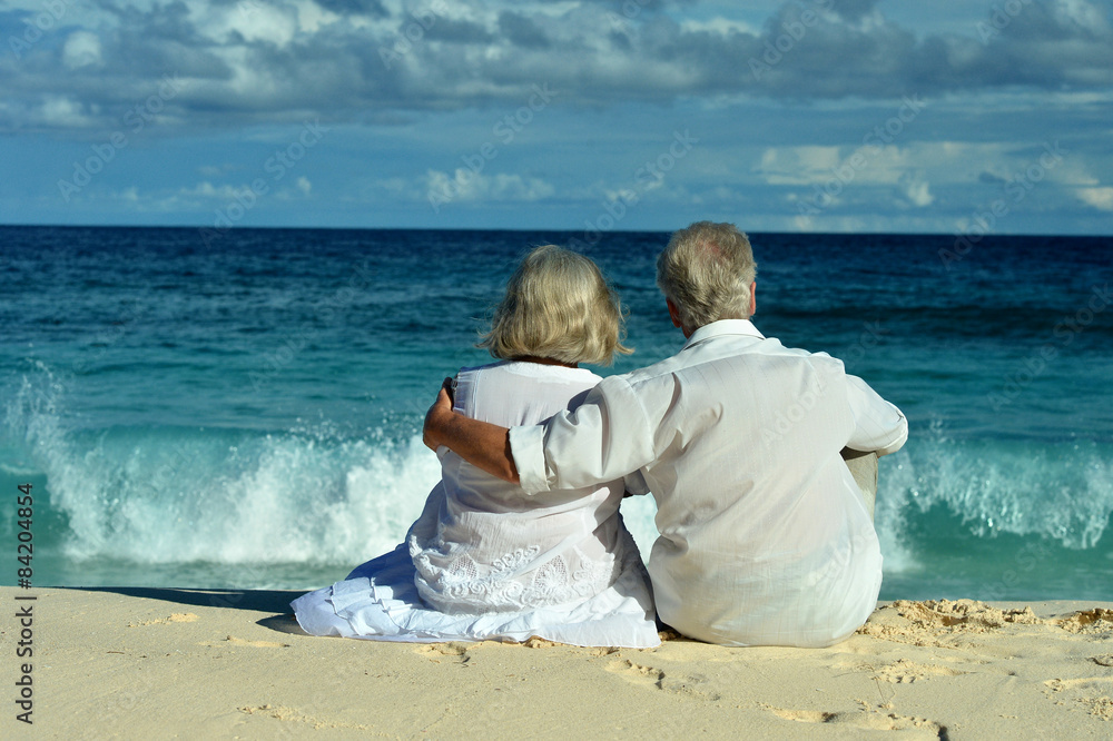 Elderly couple sitting on the shore Elderly couple sitting on the shore
