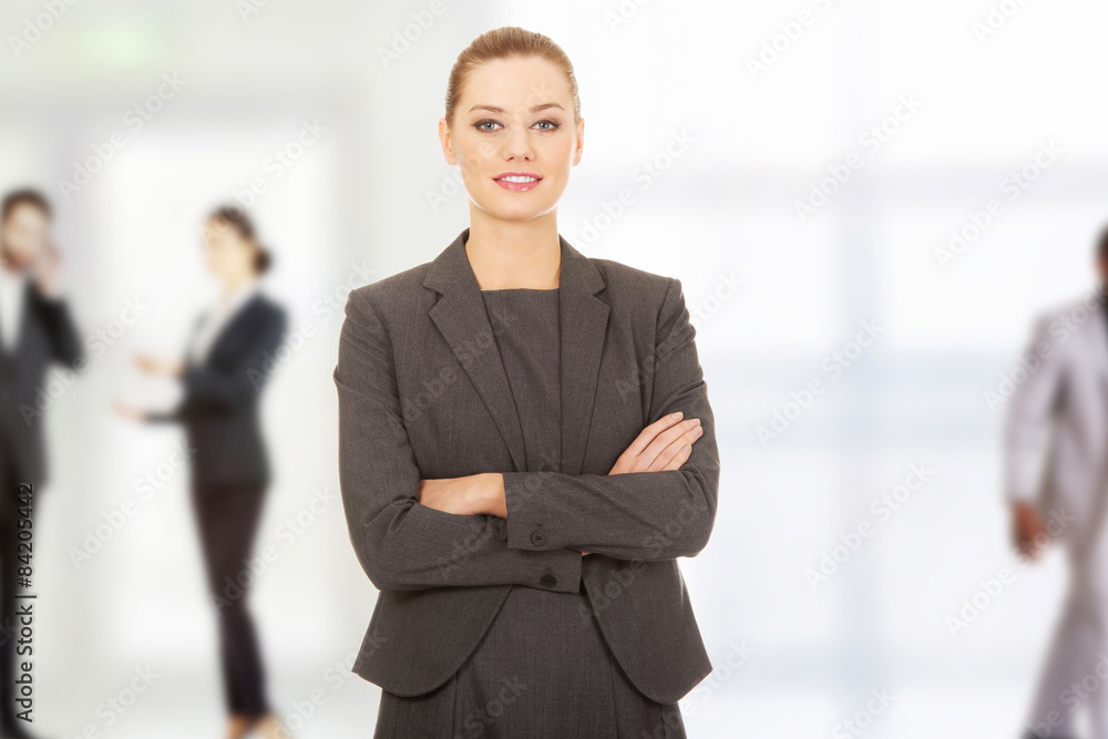 Happy businesswoman with crossed arms.