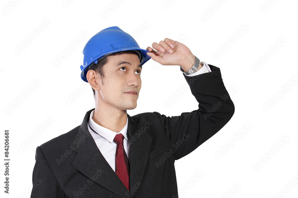 Construction worker in suit looking up, isolated on white Construction worker in suit looking up, isolated on white