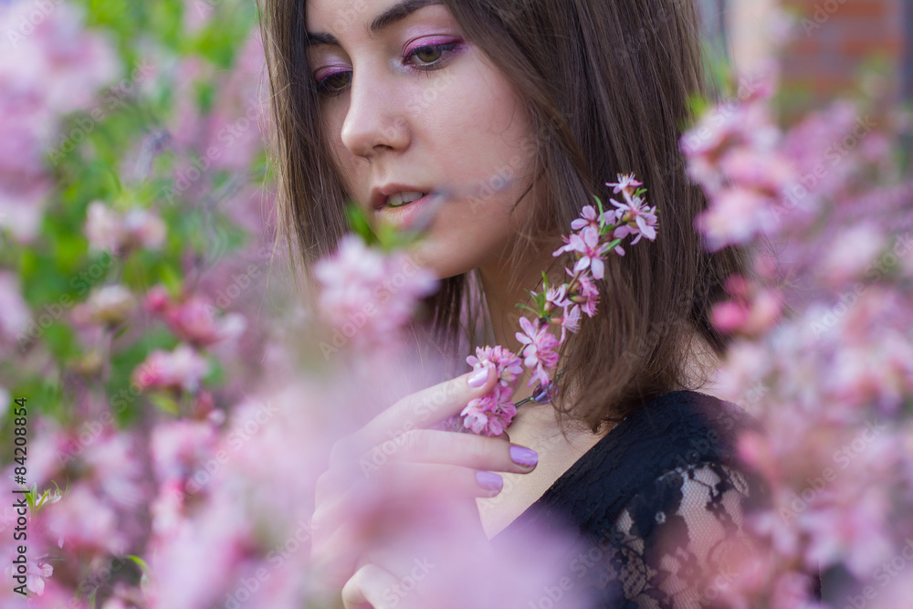 Fototapeta premium portrait of young beautiful girl in flowers