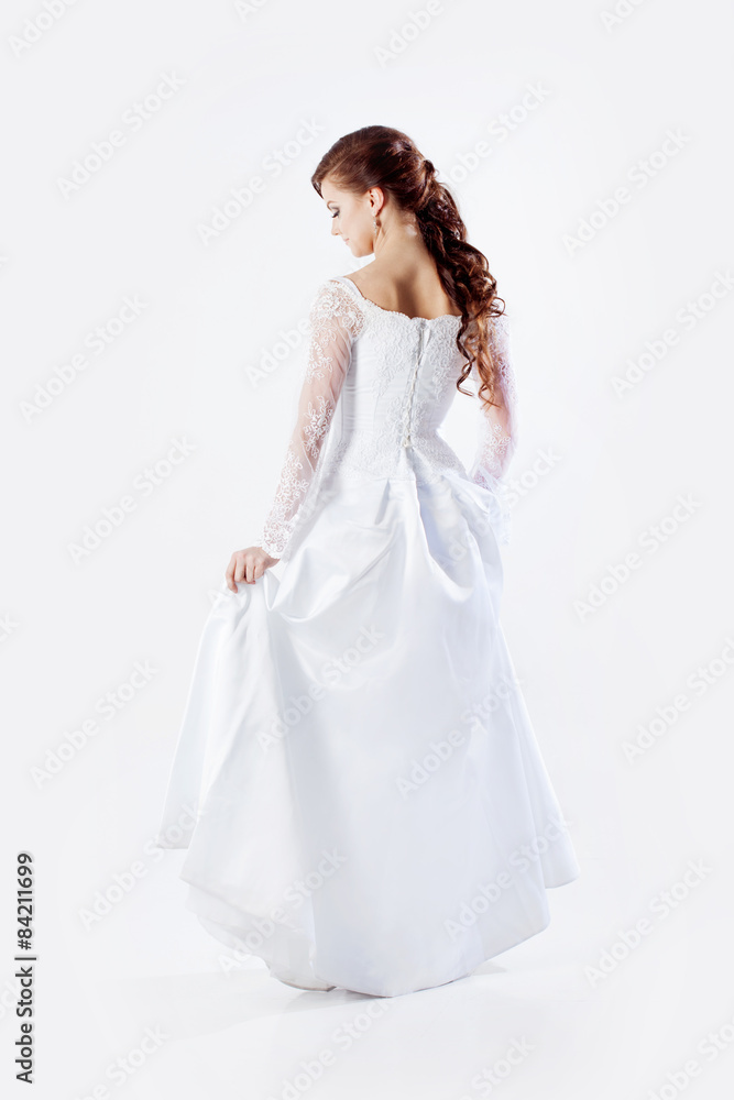 Portrait of happy bride in wedding dress, white background