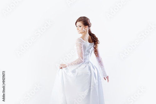 Portrait of happy bride in wedding dress  white background