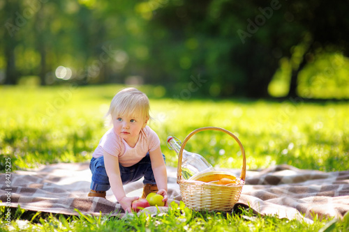 Toddler boy in sunny park