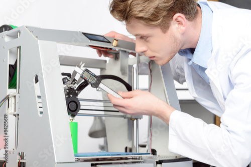 Scientist working with three-dimensional printer