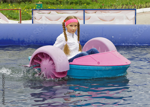 Girl riding on a child boat
