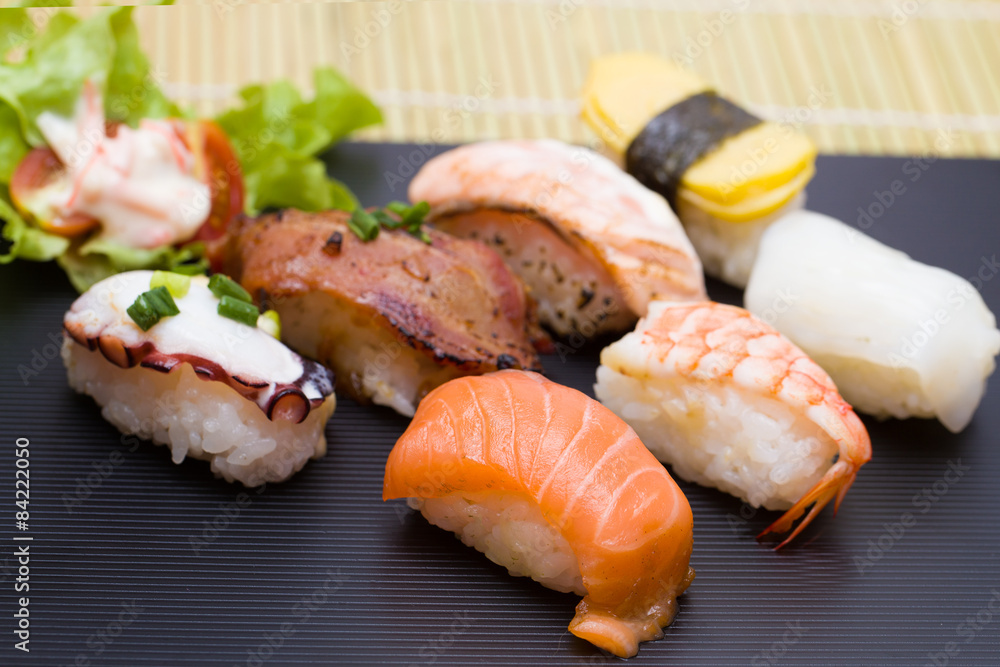 Sushi assortment on black dish, close up