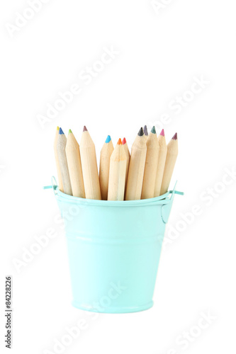Blue bucket with pencils isolated on white