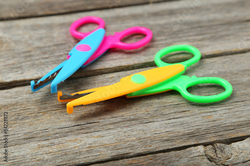 Figured scissors on grey wooden background