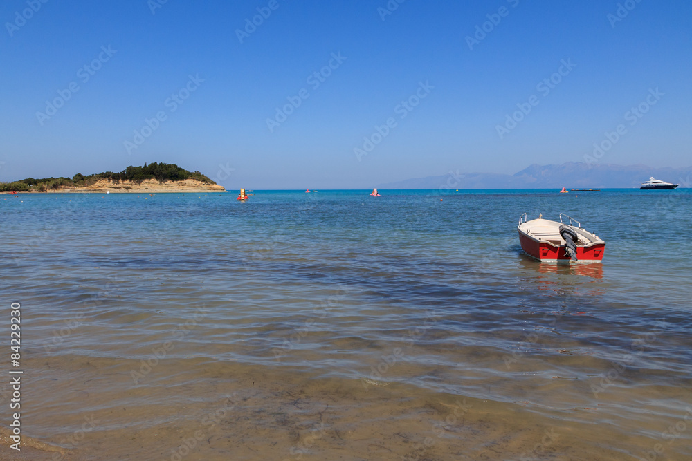 Boat in the beautiful blue water off the Corfu coast