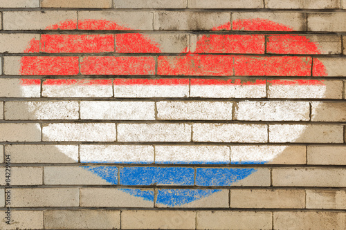 Fotobehang heart shape flag of Netherlands on brick wall