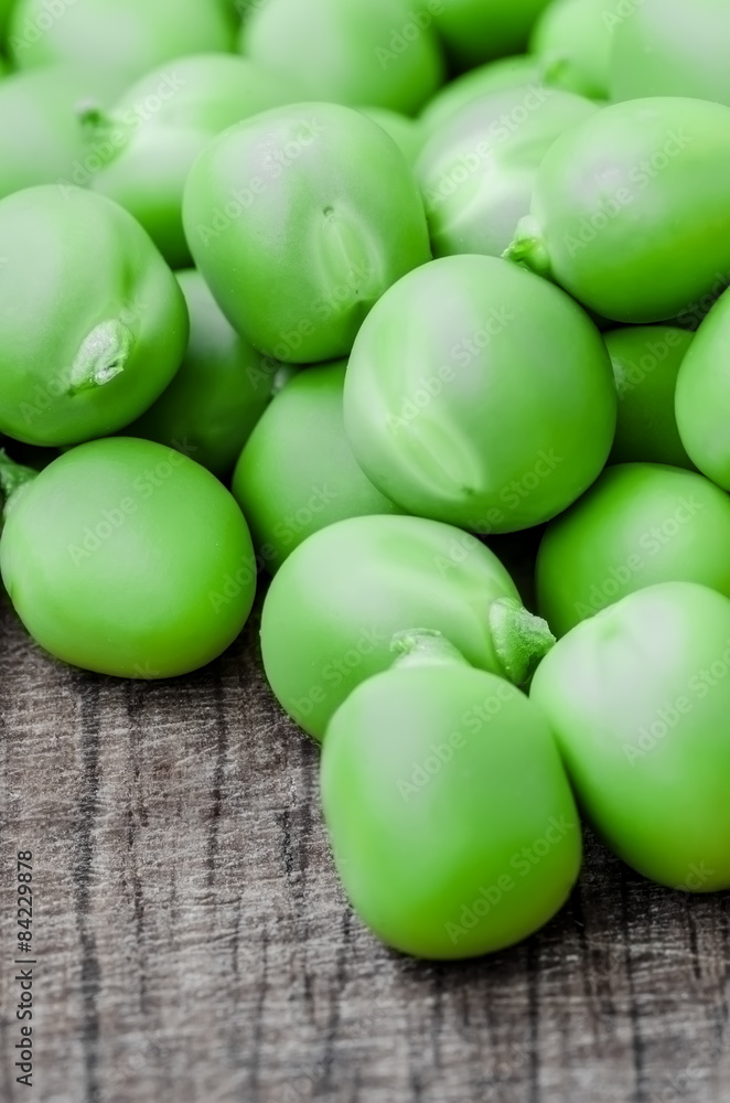 Green organic peas on wooden background, shallow focus Green organic peas on wooden background, shallow focus