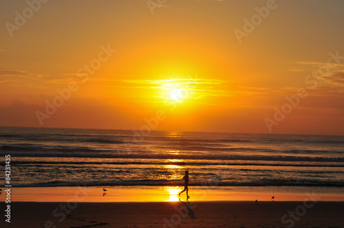 Lone sunrise jogger on Surfers Paradise beach