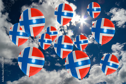 many balloons with norway flag on sky