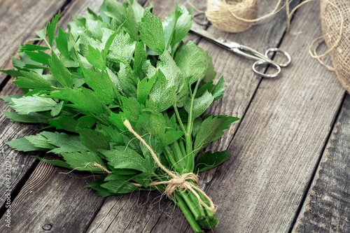 Lovage leaves on rustic wooden table