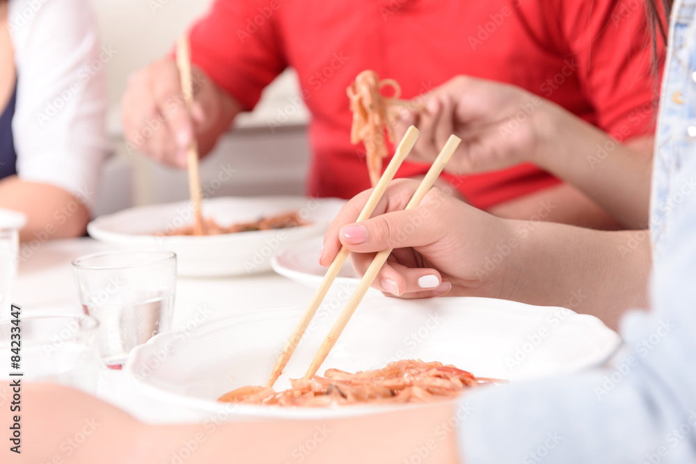 Asians eating with sticks. Asians eating with sticks.
