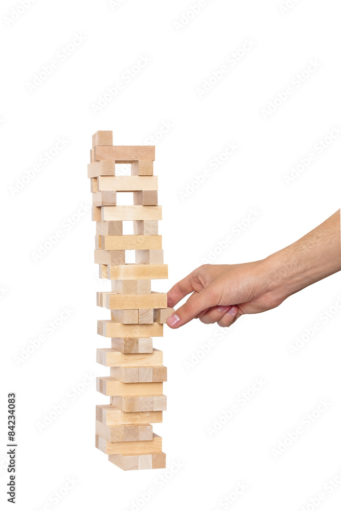 Hand playing in jenga on white background Hand playing in jenga on white background