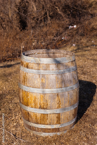 Worn wooden barrel casting shadow.