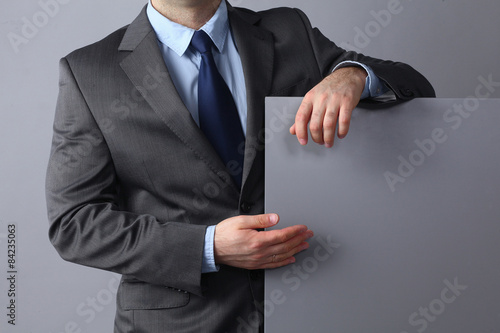 Businessman holding a blank board