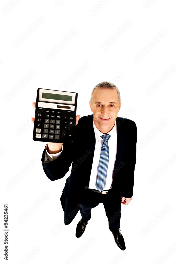 Happy businessman holding a calculator Happy businessman holding a calculator