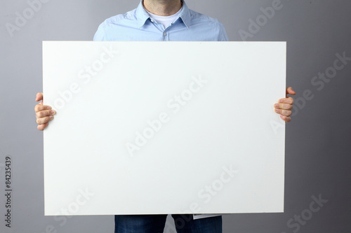 Businessman holding a blank  board