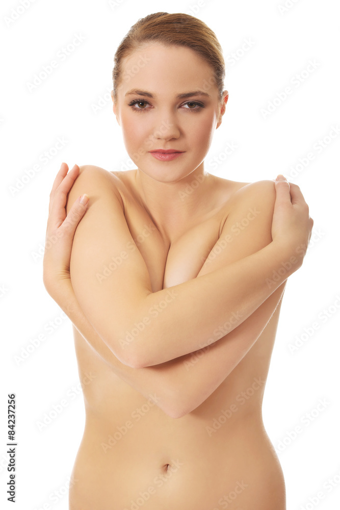 Obraz premium Young topless woman covering her breast.