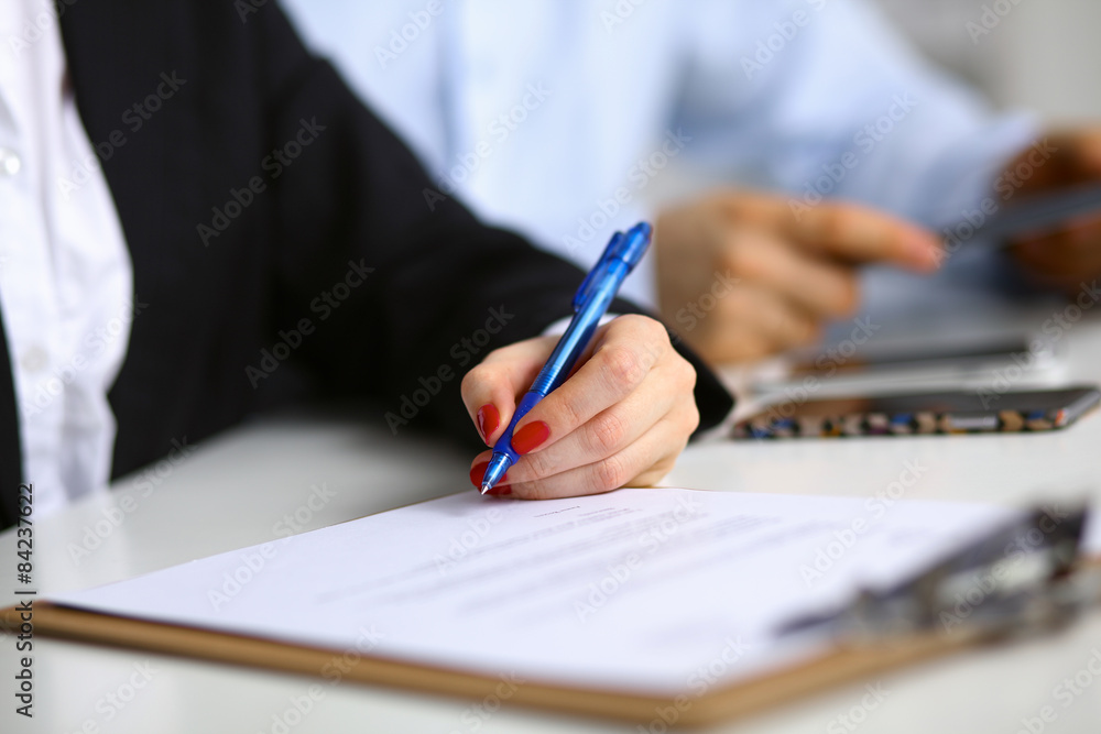 Young woman sitting at the desk with folder Young woman sitting at the desk with folder
