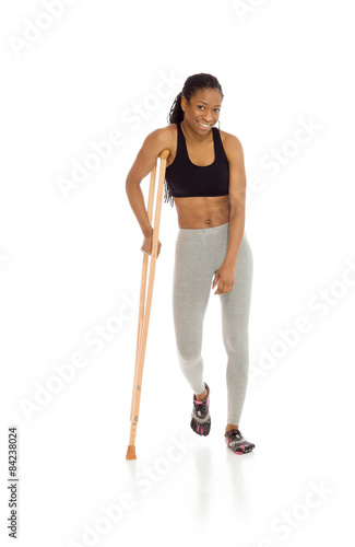 Model shot in studio on white injured with crutch Fototapeta