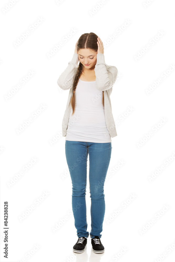 Teen woman covering ears with hands. Teen woman covering ears with hands.