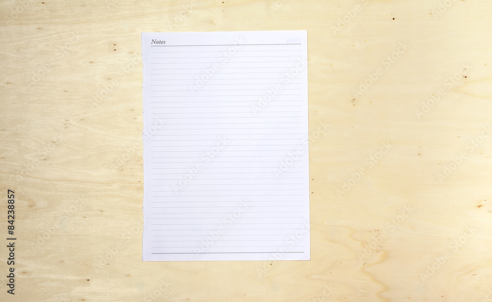 Blank white note sheet on wood background Blank white note sheet on wood background