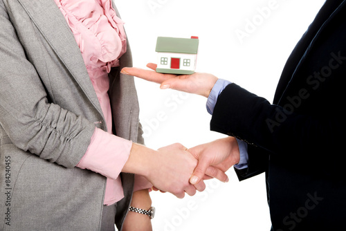 Businesswoman giving a house to her partner.