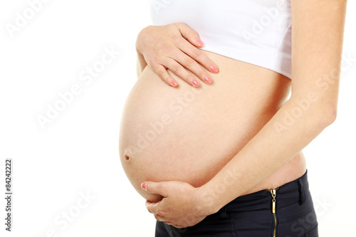 Belly of pregnant woman on white background © 5second