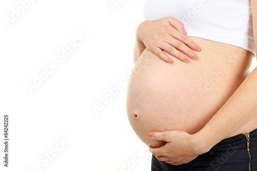 Belly of pregnant woman on white background