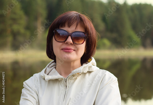 Portrait of a beautiful middle-aged woman in sunglasses