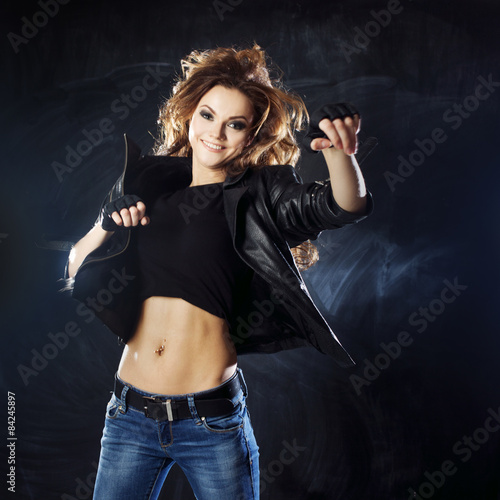 Fototapeta Naklejka Na Ścianę i Meble -  smiling young woman dancing, hair flying