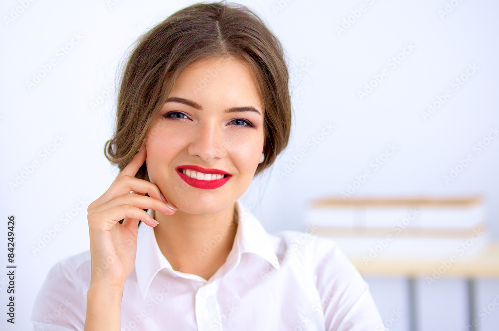 Attractive businesswoman sitting in the office Attractive businesswoman sitting in the office