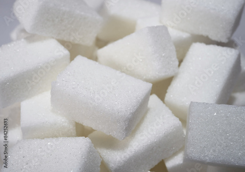 isolated pile of sugar cubes close up view in diet concept