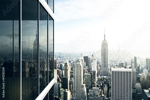 Cityscape reflected in the glass of an office building