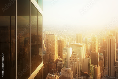 Cityscape reflected in the glass of an office building at sunset
