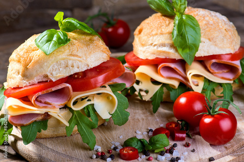 Italian ciabatta with ham and cheese on the wooden background