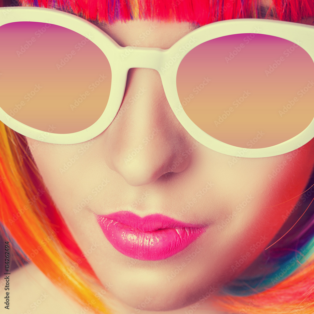 beautiful woman wearing colorful wig and white sunglasses agains beautiful woman wearing colorful wig and white sunglasses agains