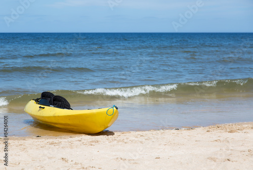 Yellow two seat kayak on a sandy beach © scphoto48