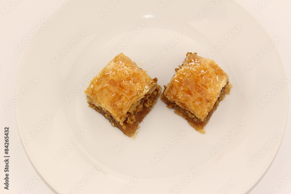 Traditional Turkish Ramadan dessert baklava on a white plate Traditional Turkish Ramadan dessert baklava on a white plate