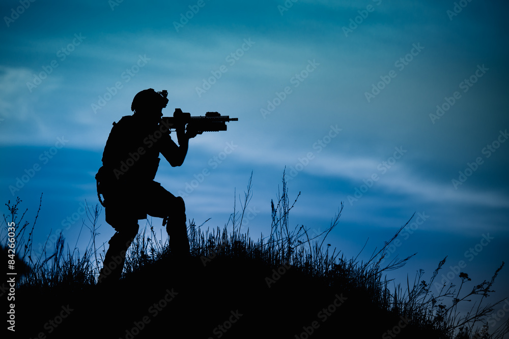 Silhouette of military soldier or officer with weapons at night. Silhouette of military soldier or officer with weapons at night.