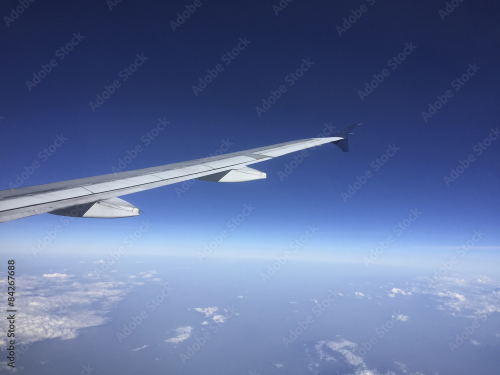 Fototapeta premium Aircraft Wing above Clouds