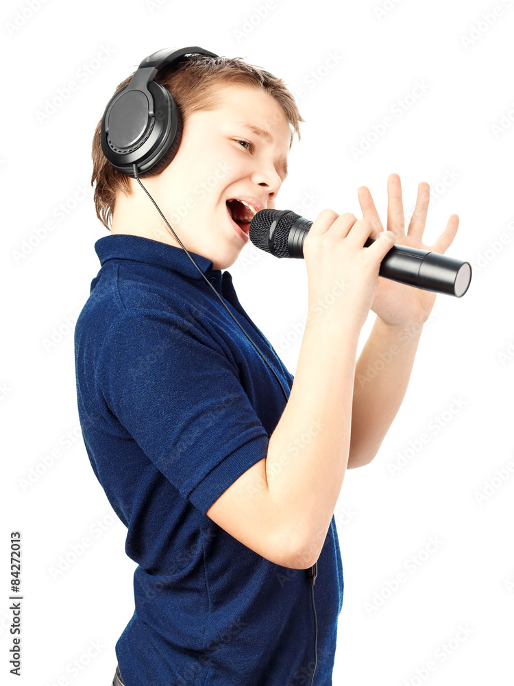 Obraz premium Boy singing into a microphone. Very emotional.