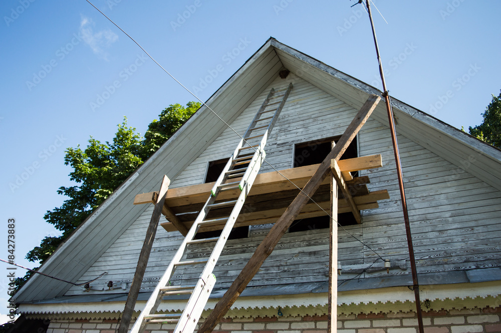 Renovation of a village house with ladder and scaffolding